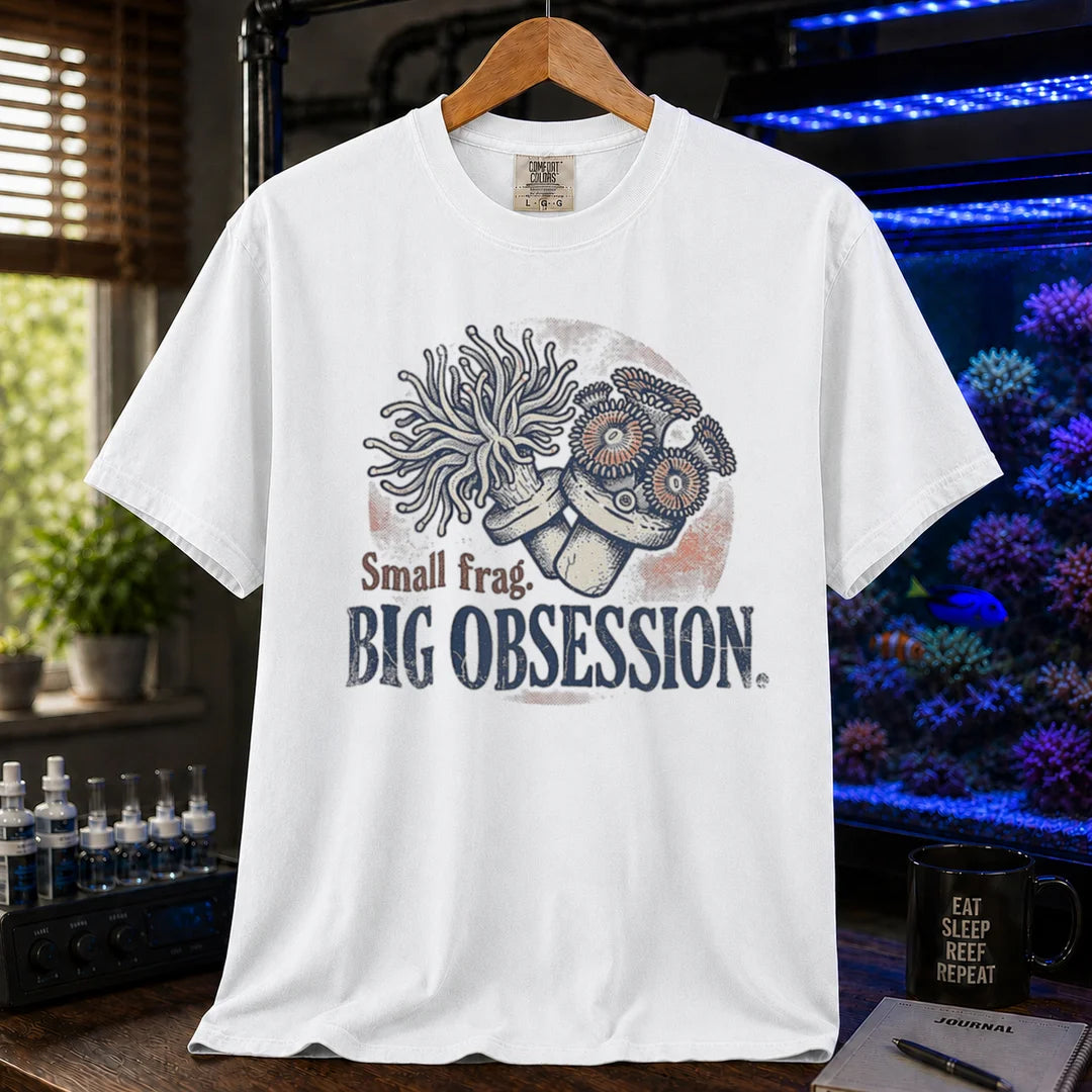 Saltwater aquarium graphic t-shirt on a pure solid white fabric background featuring an illustration of coral frags and text: Small frag. BIG OBSESSION., white crew neck tee