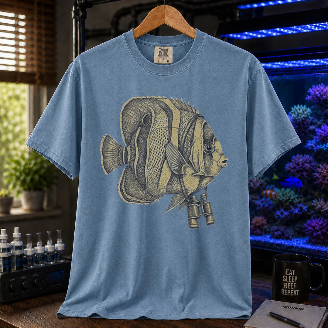 Saltwater aquarium graphic t-shirt featuring a vintage stippled illustration of a hybrid Copperband Butterflyfish wearing binoculars around its neck, blue crew neck tee