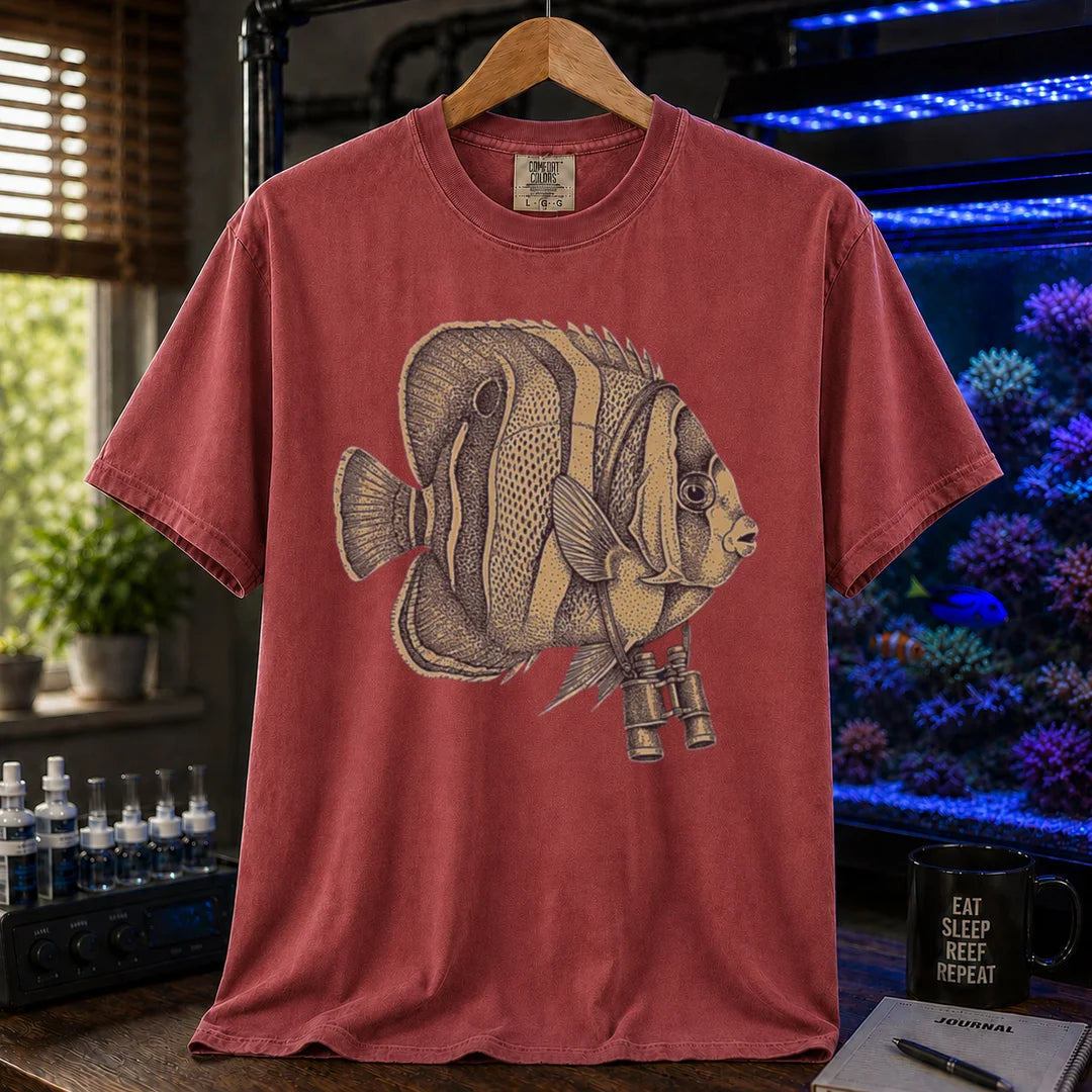 Saltwater aquarium graphic t-shirt featuring a vintage stippled illustration of a hybrid Copperband Butterflyfish wearing binoculars around its neck, maroon crew neck tee