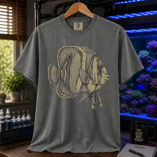 Saltwater aquarium graphic t-shirt featuring a vintage stippled illustration of a hybrid Copperband Butterflyfish wearing binoculars around its neck, khaki crew neck tee