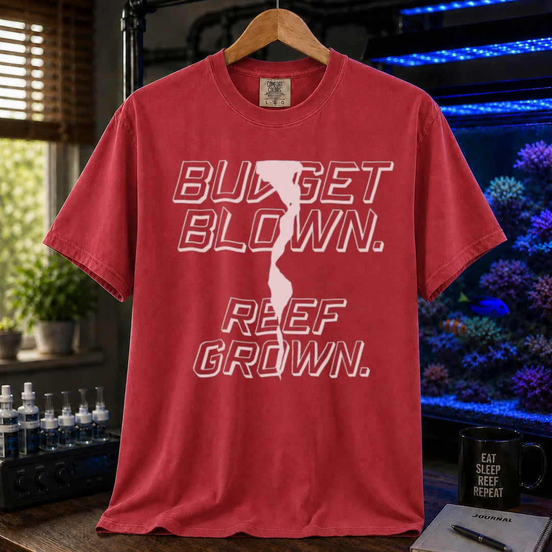 Saltwater aquarium graphic t-shirt featuring bold retro outline typography with the text: BUDGET BLOWN. REEF GROWN., maroon crew neck tee
