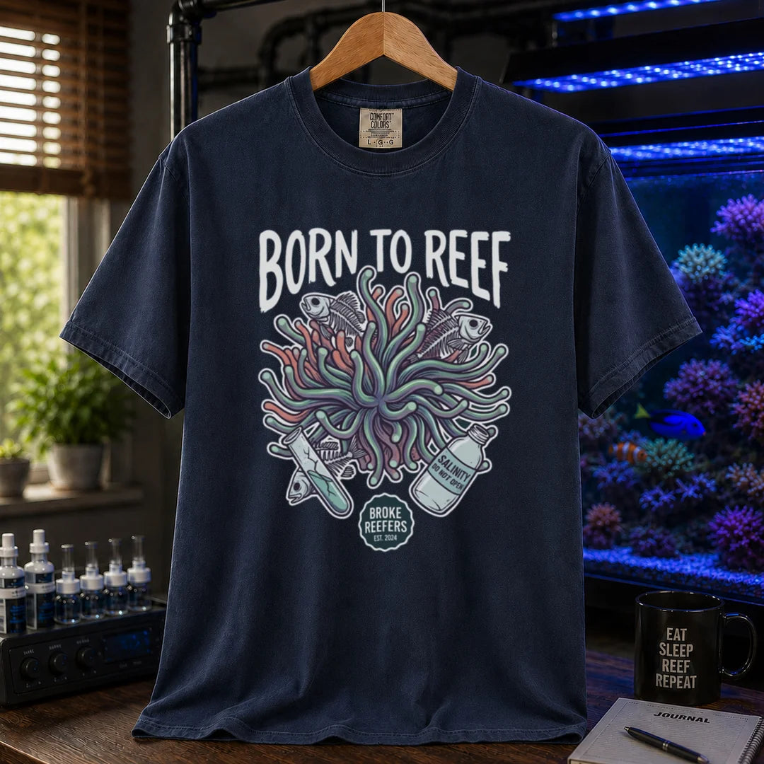 Saltwater aquarium graphic t-shirt featuring an anemone illustration and text: BORN TO REEF, BROKE REEFERS EST. 2024, navy crew neck tee