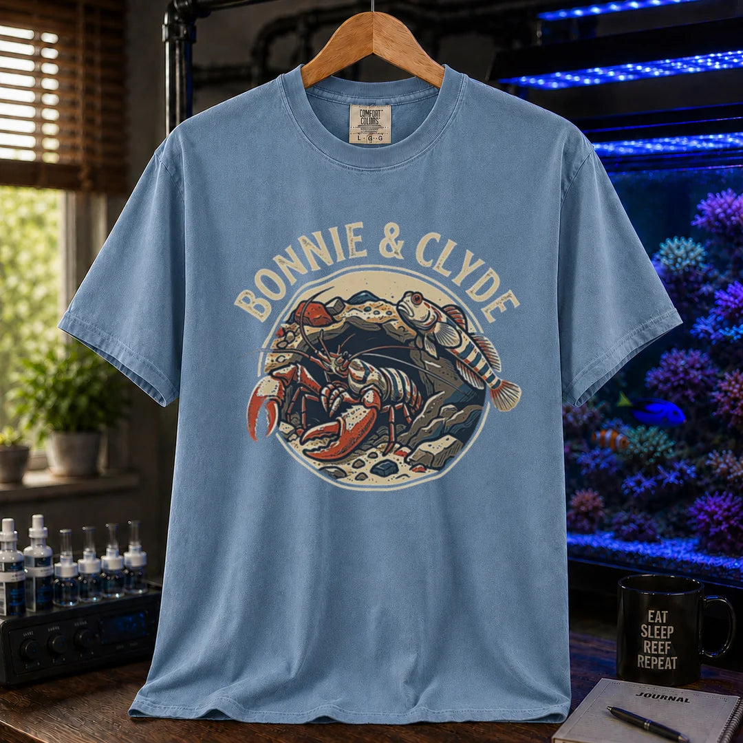 Saltwater aquarium graphic t-shirt featuring a retro emblem of a pistol shrimp and goby in a rock cave and text: BONNIE & CLYDE, blue crew neck tee
