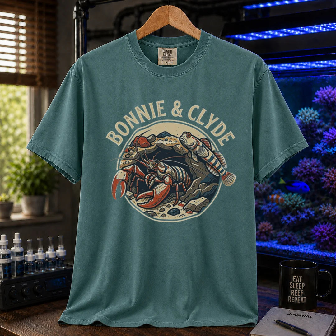 Saltwater aquarium graphic t-shirt featuring a retro emblem of a pistol shrimp and goby in a rock cave and text: BONNIE & CLYDE, green crew neck tee