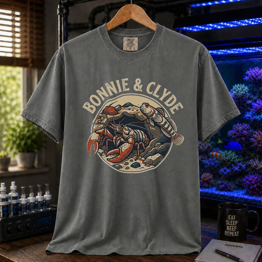 Saltwater aquarium graphic t-shirt featuring a retro emblem of a pistol shrimp and goby in a rock cave and text: BONNIE & CLYDE, khaki crew neck tee