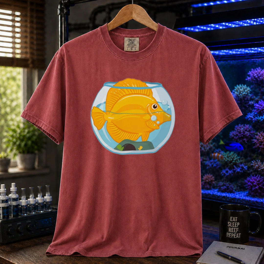 Saltwater aquarium graphic t-shirt featuring a bright yellow Tang fish crammed inside a tiny fishbowl illustration, maroon crew neck tee