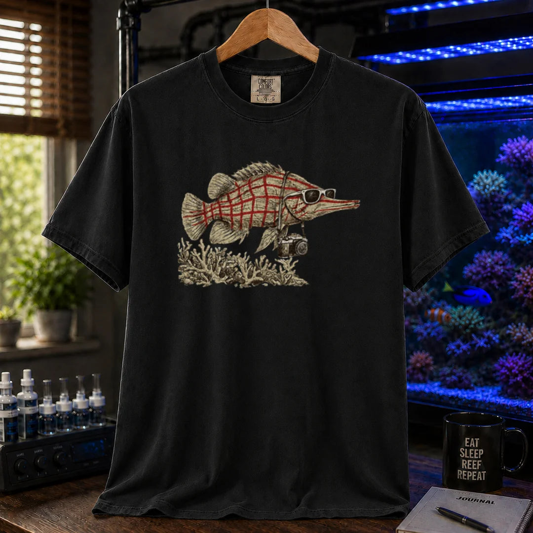 Saltwater aquarium graphic t-shirt featuring a vintage illustration of a Longnose Hawkfish wearing sunglasses and a camera over a coral reef, black crew neck tee