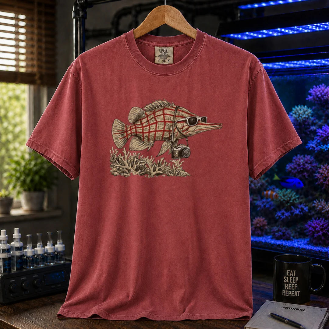 Saltwater aquarium graphic t-shirt featuring a vintage illustration of a Longnose Hawkfish wearing sunglasses and a camera over a coral reef, maroon crew neck tee