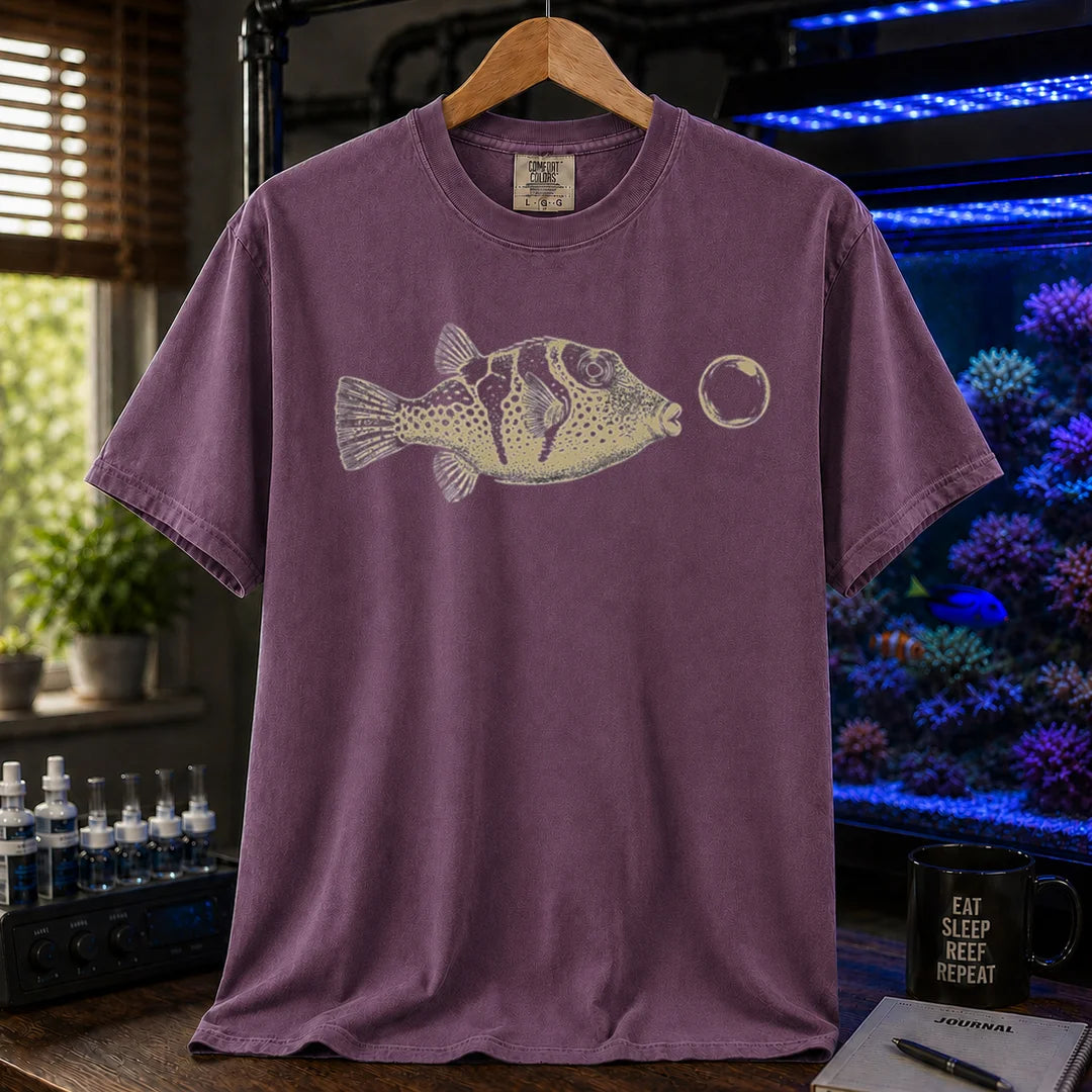 Saltwater aquarium graphic t-shirt featuring a vintage illustration of a Valentini Puffer blowing a bubble, purple crew neck tee