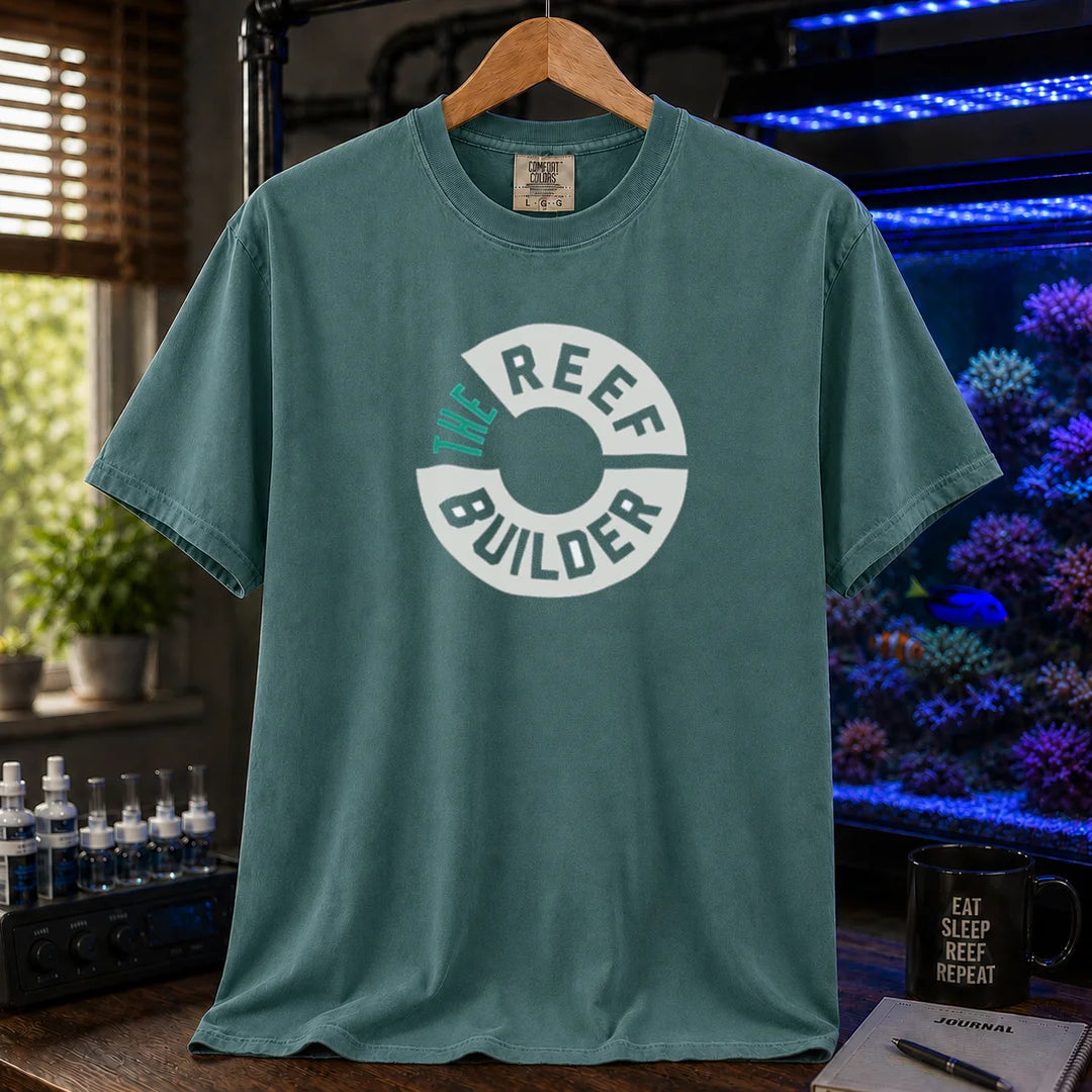 Saltwater aquarium graphic t-shirt featuring a circular badge with teal and white text reading: THE REEF BUILDER, green crew neck tee