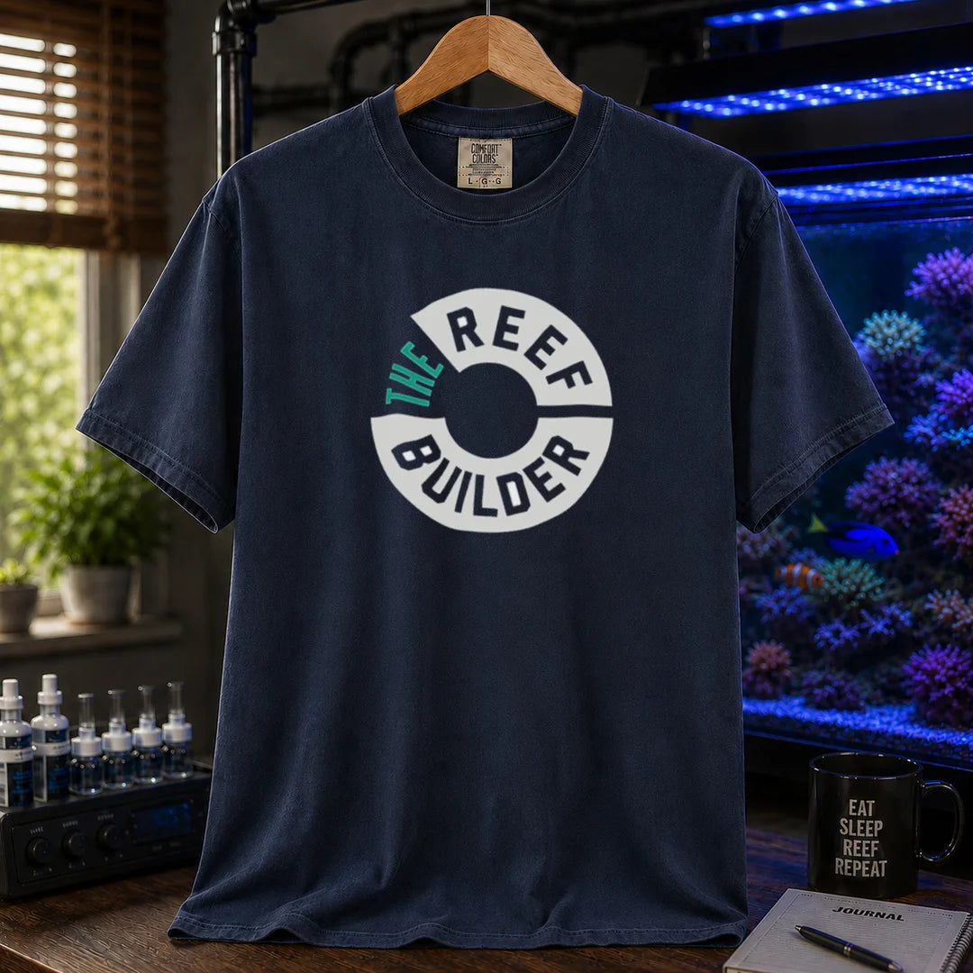 Saltwater aquarium graphic t-shirt featuring a circular badge with teal and white text reading: THE REEF BUILDER, navy crew neck tee