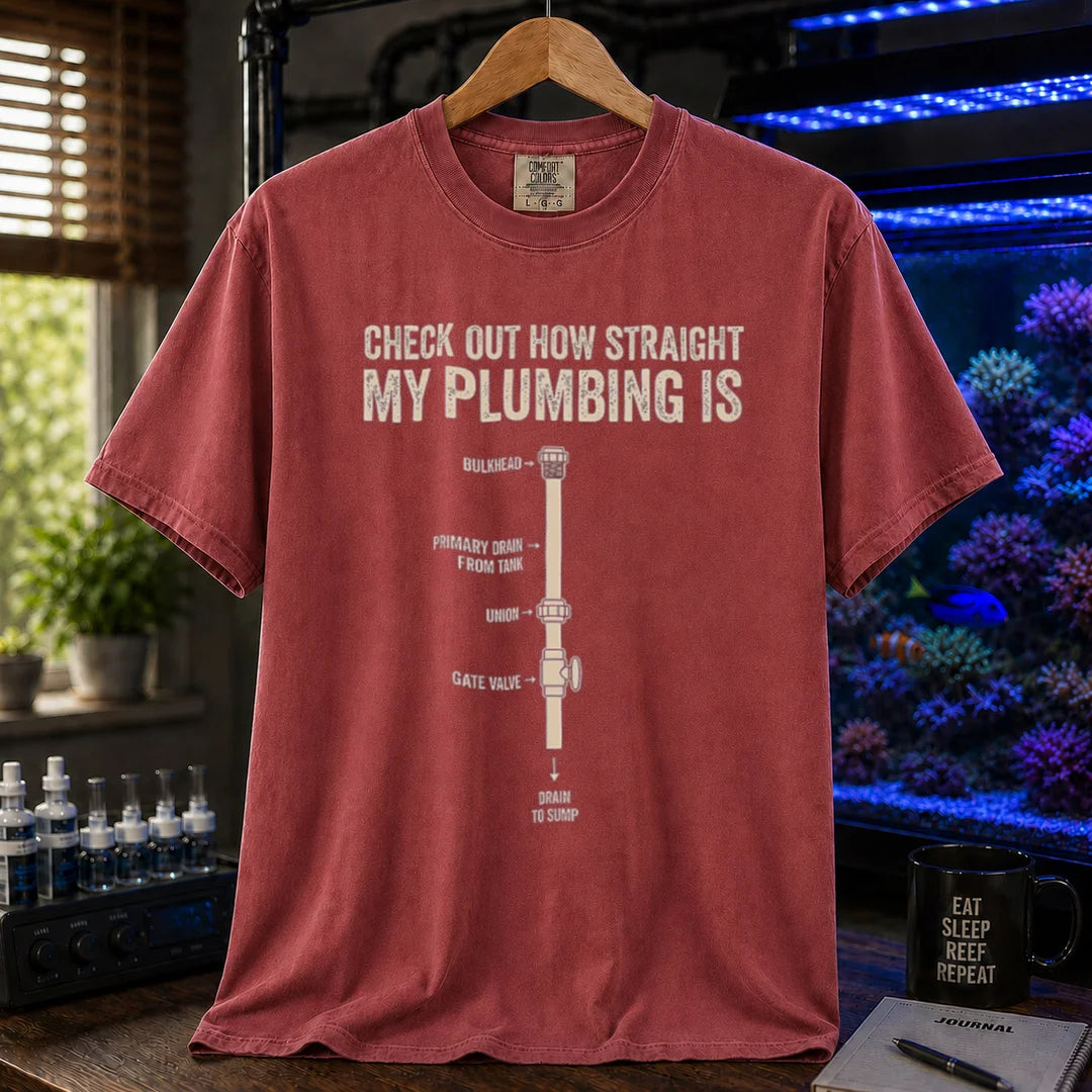 Saltwater aquarium graphic t-shirt featuring a technical plumbing schematic with labeled parts and text: CHECK OUT HOW STRAIGHT MY PLUMBING IS, maroon crew neck tee