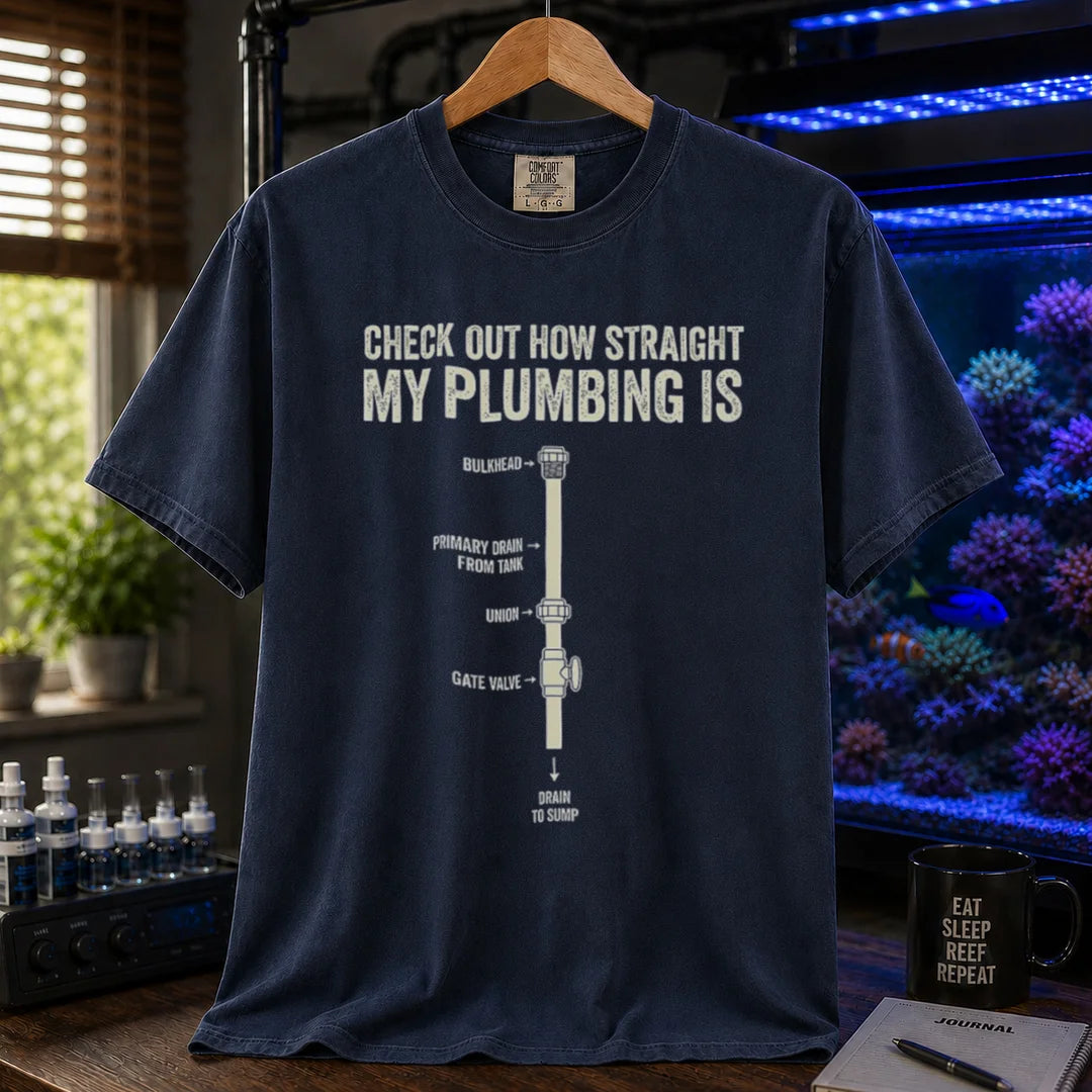 Saltwater aquarium graphic t-shirt featuring a technical plumbing schematic with labeled parts and text: CHECK OUT HOW STRAIGHT MY PLUMBING IS, navy crew neck tee