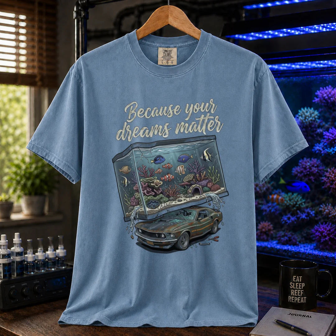 Saltwater aquarium graphic t-shirt featuring a massive reef tank crushing a classic car with text: Because your dreams matter, blue crew neck tee