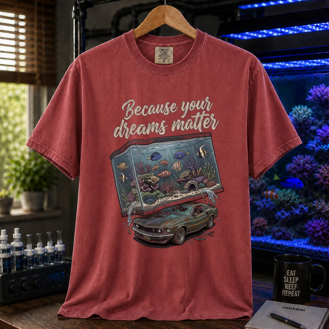 Saltwater aquarium graphic t-shirt featuring a massive reef tank crushing a classic car with text: Because your dreams matter, maroon crew neck tee