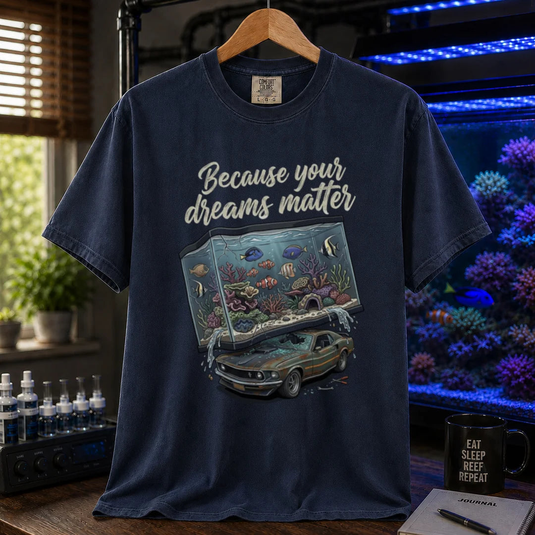Saltwater aquarium graphic t-shirt featuring a massive reef tank crushing a classic car with text: Because your dreams matter, navy crew neck tee