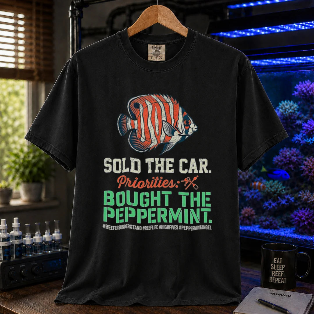 Saltwater aquarium graphic t-shirt featuring a Peppermint Angelfish illustration and text: SOLD THE CAR. Priorities: BOUGHT THE PEPPERMINT., black crew neck tee