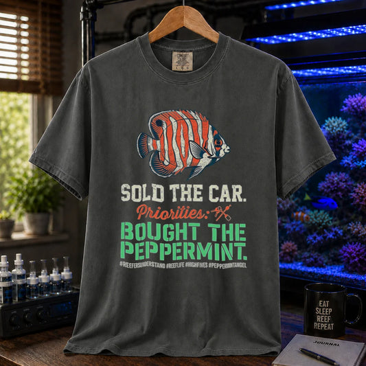 Saltwater aquarium graphic t-shirt featuring a Peppermint Angelfish illustration and text: SOLD THE CAR. Priorities: BOUGHT THE PEPPERMINT., khaki crew neck tee