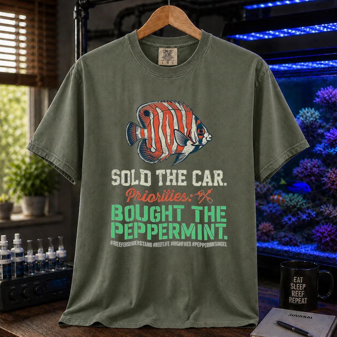 Saltwater aquarium graphic t-shirt featuring a Peppermint Angelfish illustration and text: SOLD THE CAR. Priorities: BOUGHT THE PEPPERMINT., military green crew neck tee
