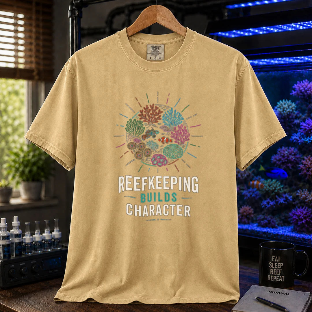 Saltwater aquarium graphic t-shirt featuring a colorful coral reef globe illustration and text: REEFKEEPING BUILDS CHARACTER, mustard crew neck tee