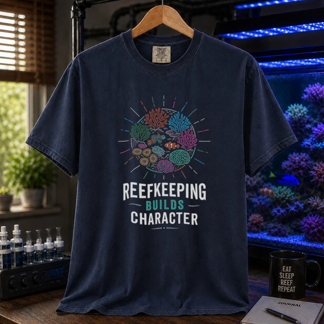 Saltwater aquarium graphic t-shirt featuring a colorful coral reef globe illustration and text: REEFKEEPING BUILDS CHARACTER, navy crew neck tee