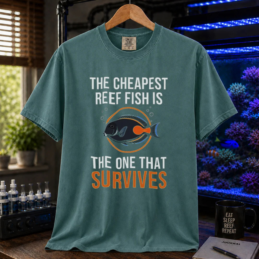 Saltwater aquarium graphic t-shirt featuring an Achilles Tang illustration inside a circular badge with text: THE CHEAPEST REEF FISH IS THE ONE THAT SURVIVES, green crew neck tee