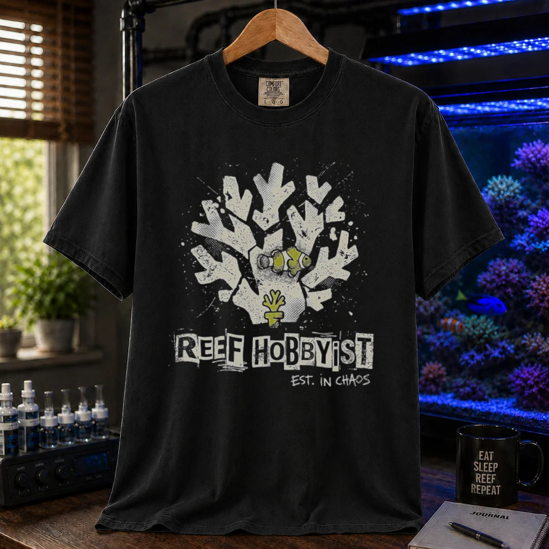 Saltwater aquarium graphic t-shirt featuring a distressed branching coral illustration with a clownfish and text: REEF HOBBYIST EST. IN CHAOS, black crew neck tee