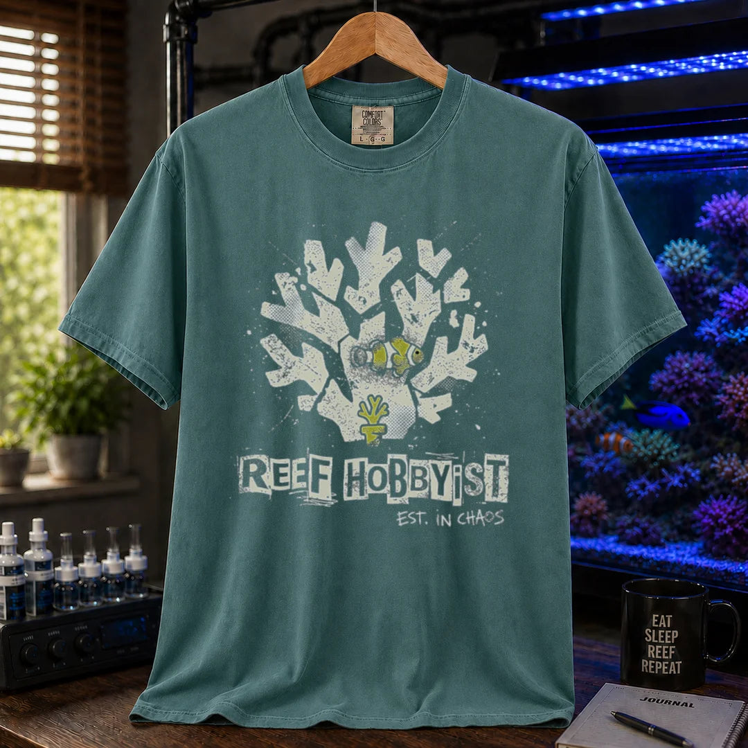 Saltwater aquarium graphic t-shirt featuring a distressed branching coral illustration with a clownfish and text: REEF HOBBYIST EST. IN CHAOS, green crew neck tee