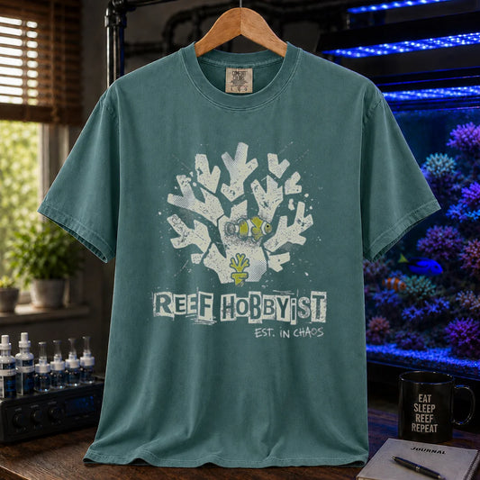 Saltwater aquarium graphic t-shirt featuring a distressed branching coral illustration with a clownfish and text: REEF HOBBYIST EST. IN CHAOS, green crew neck tee