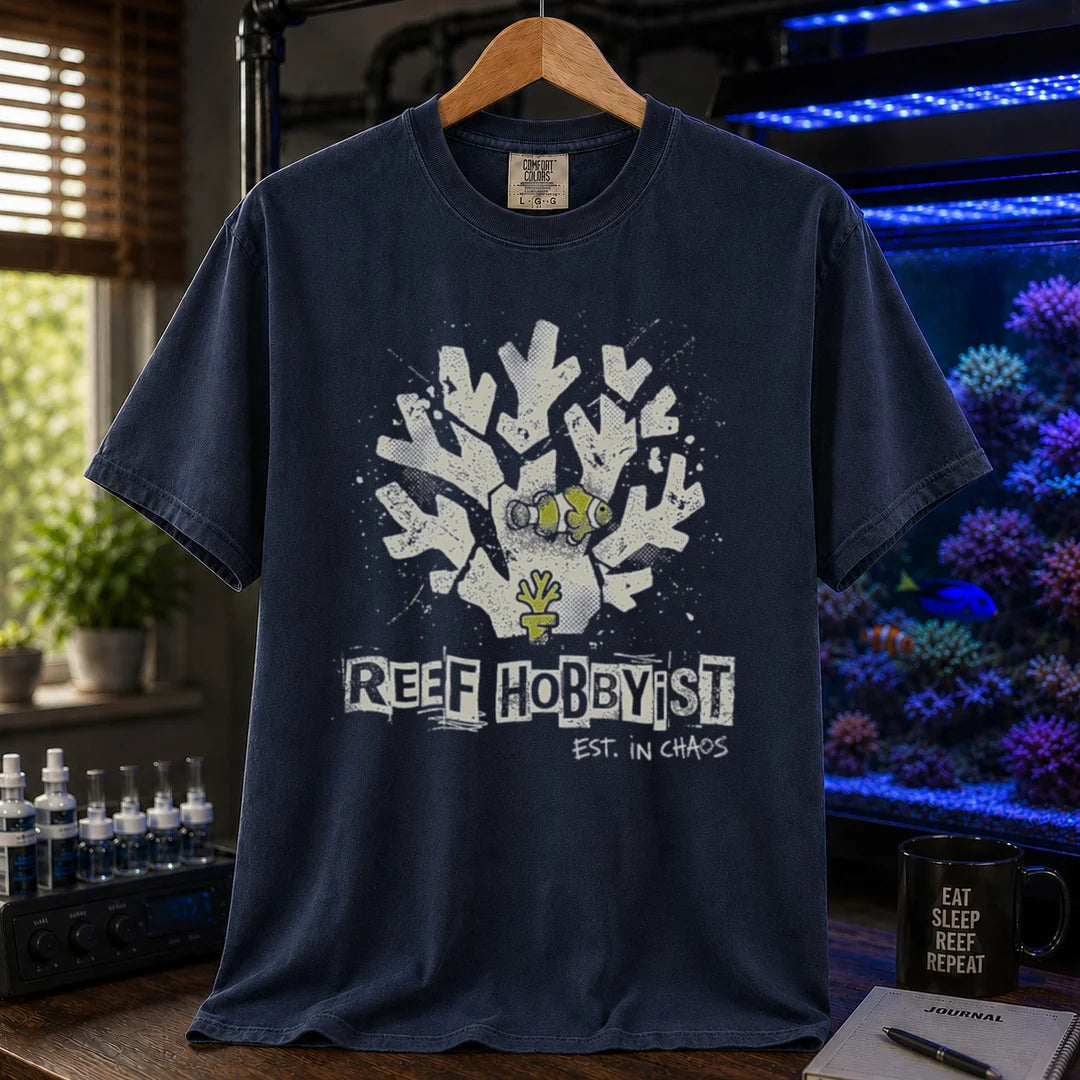 Saltwater aquarium graphic t-shirt featuring a distressed branching coral illustration with a clownfish and text: REEF HOBBYIST EST. IN CHAOS, navy crew neck tee