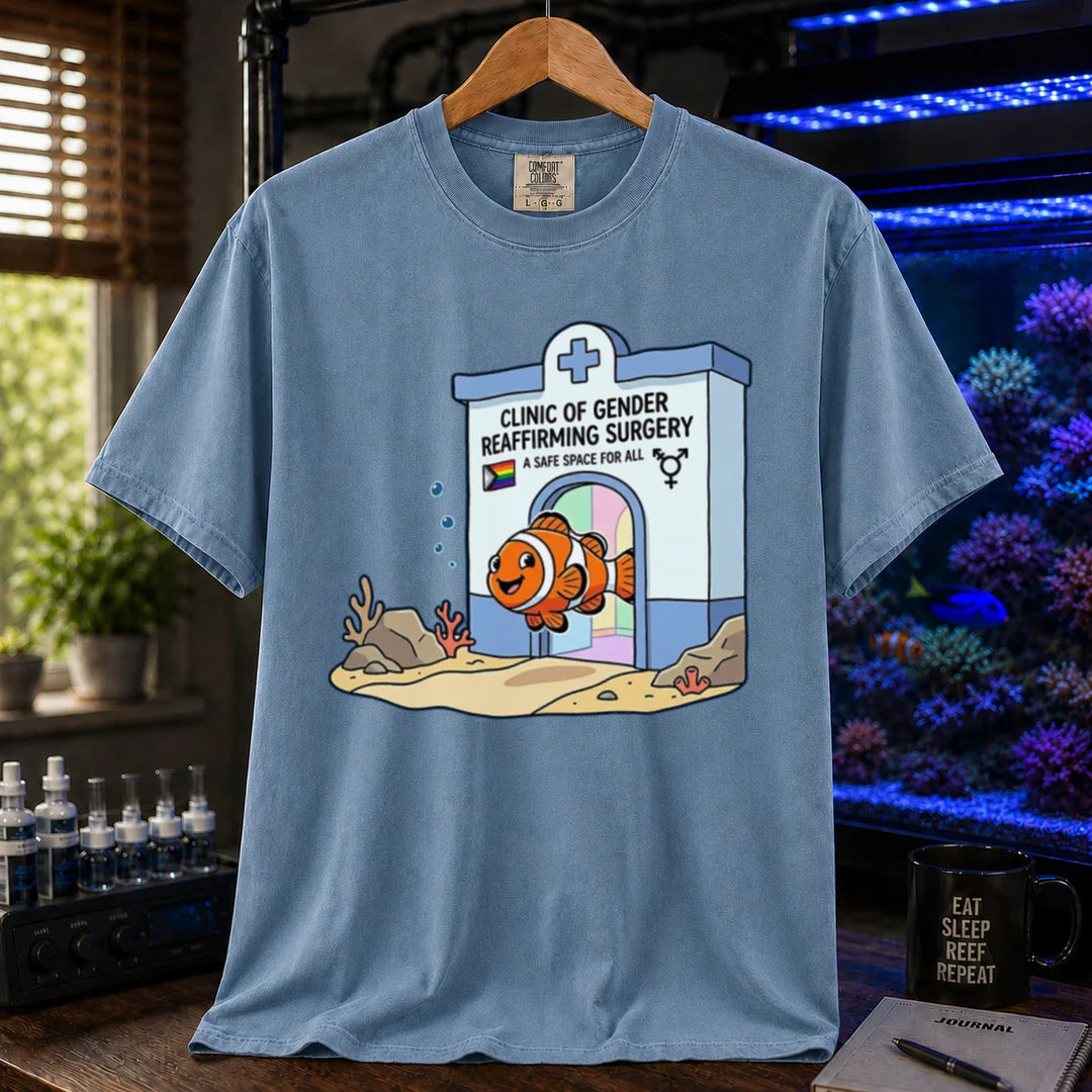 Saltwater aquarium graphic t-shirt featuring a clownfish coming out of a clinic for gender-affirming surgery, blue crew neck tee