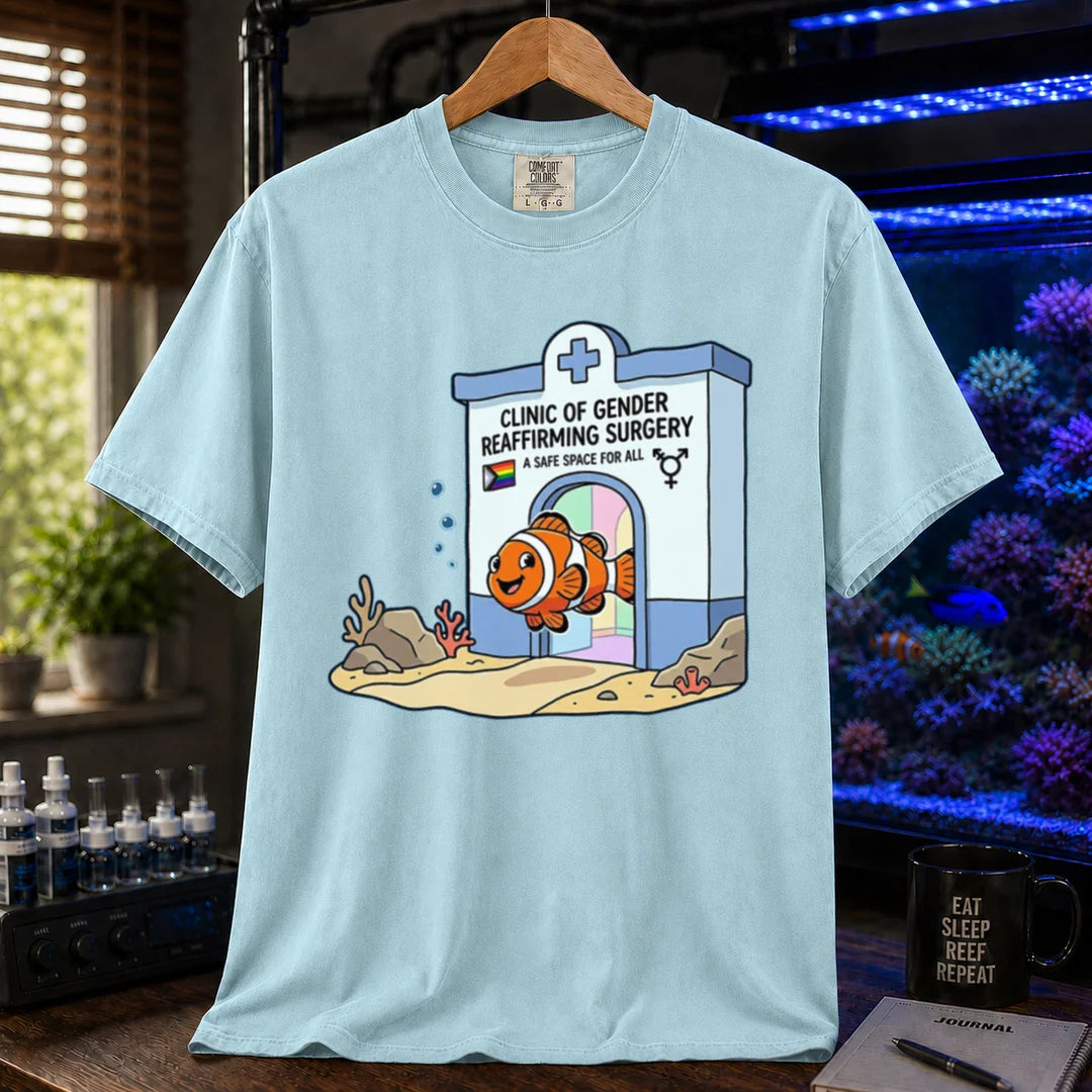 Saltwater aquarium graphic t-shirt featuring a clownfish coming out of a clinic for gender-affirming surgery, light blue crew neck tee