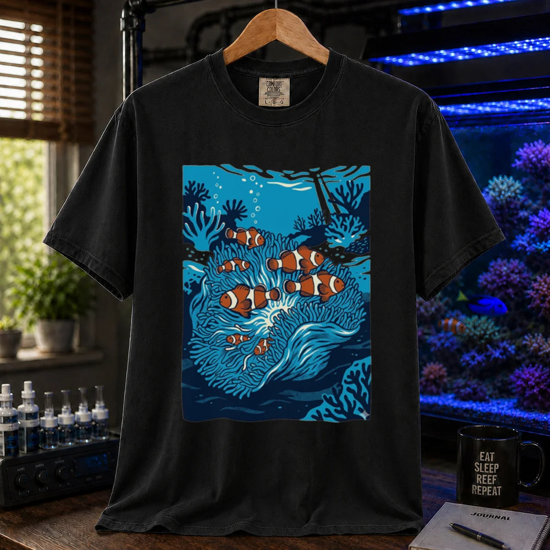 Saltwater aquarium graphic t-shirt featuring a vibrant illustration of multiple clownfish in a blue anemone biotope, black crew neck tee