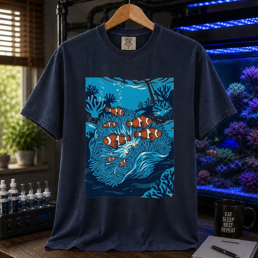 Saltwater aquarium graphic t-shirt featuring a vibrant illustration of multiple clownfish in a blue anemone biotope, navy crew neck tee