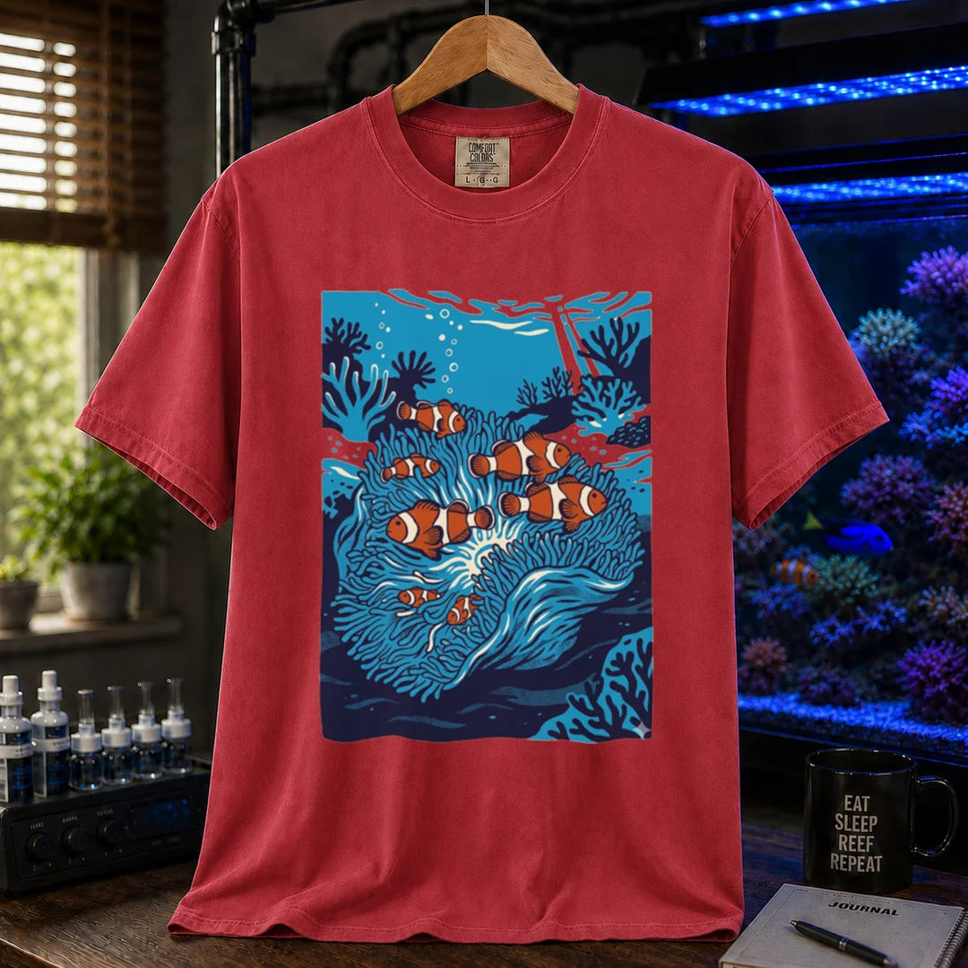 Saltwater aquarium graphic t-shirt featuring a vibrant illustration of multiple clownfish in a blue anemone biotope, red crew neck tee