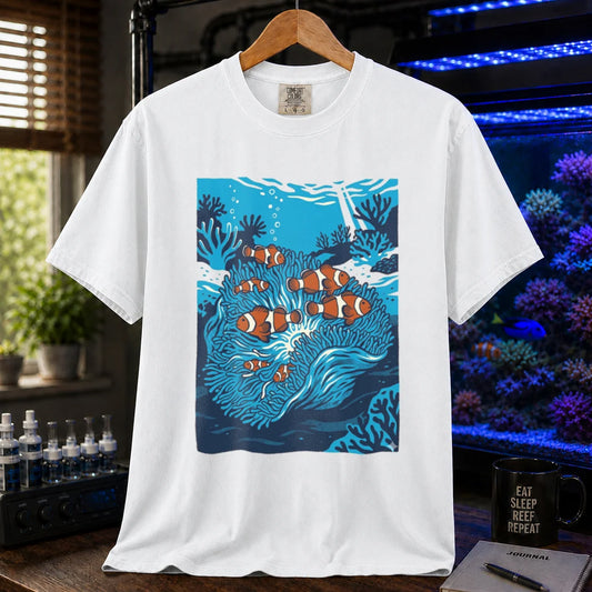 Saltwater aquarium graphic t-shirt featuring a vibrant illustration of multiple clownfish in a blue anemone biotope, white crew neck tee