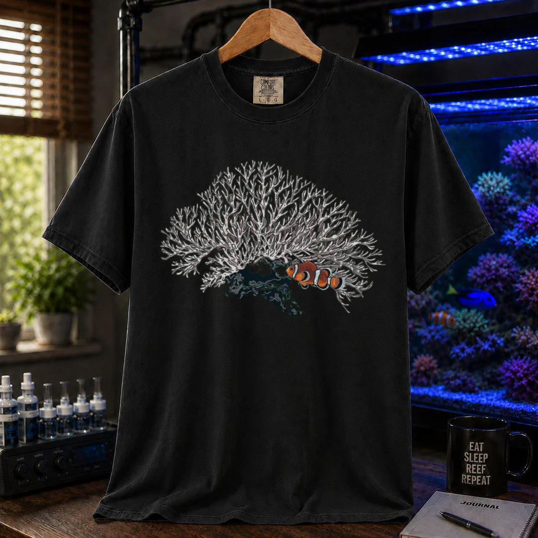 Saltwater aquarium graphic t-shirt featuring a detailed white branching coral illustration with a clownfish nestled underneath, black crew neck tee