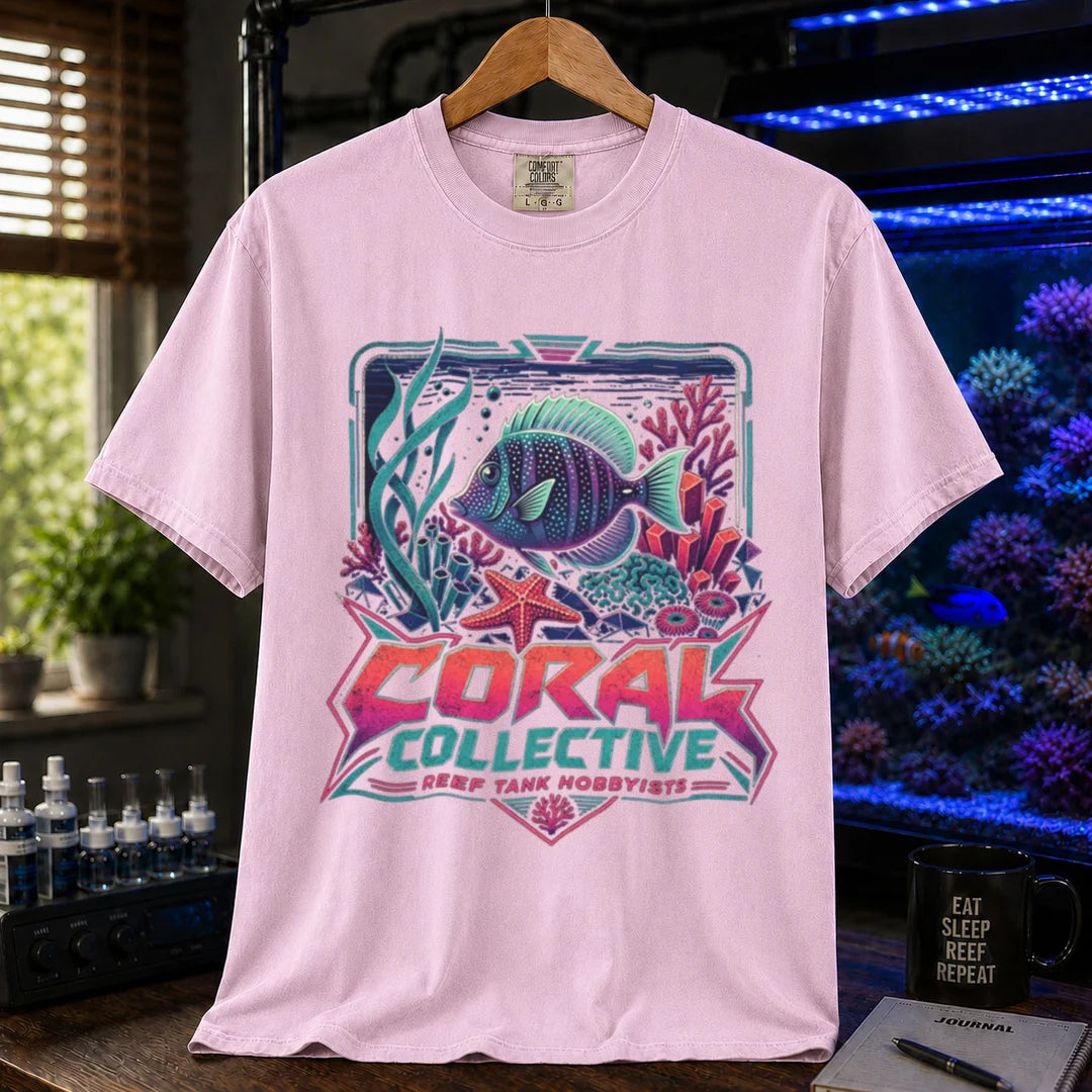 Saltwater aquarium graphic t-shirt featuring a vibrant retro-styled coral reef illustration and text: CORAL COLLECTIVE REEF TANK HOBBYISTS, pink crew neck tee