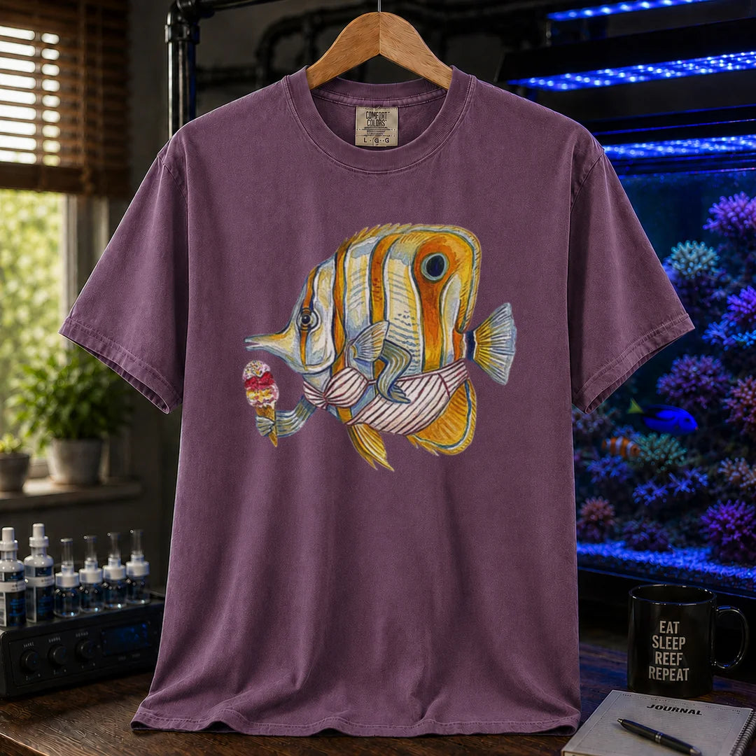Saltwater aquarium graphic t-shirt featuring a humorous painted illustration of a Copperband Butterflyfish in a bikini holding an ice cream, purple crew neck tee