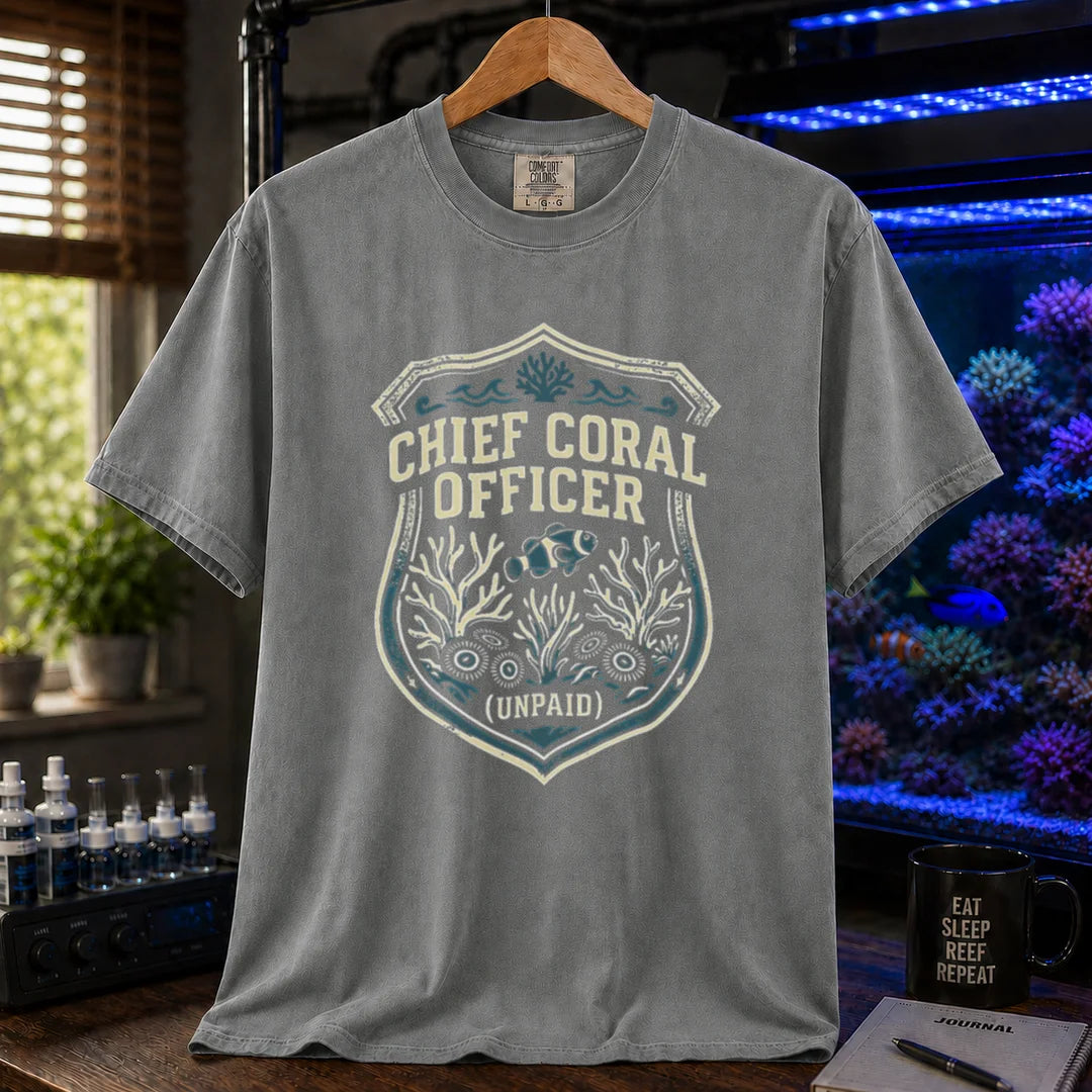 Saltwater aquarium graphic t-shirt featuring a badge illustration with text: CHIEF CORAL OFFICER (UNPAID), grey crew neck tee