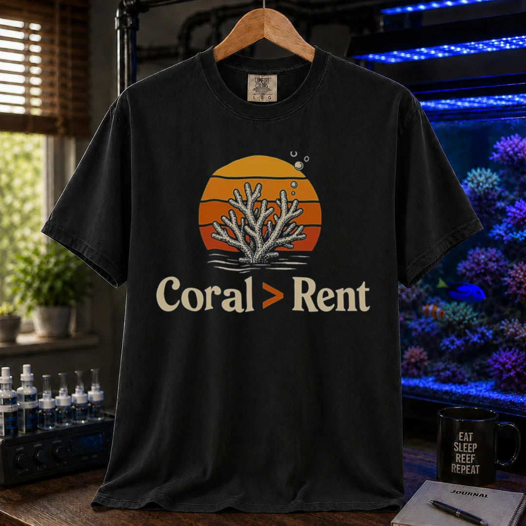 Saltwater aquarium graphic t-shirt featuring a retro sunset and coral illustration with text: Coral > Rent, black crew neck tee