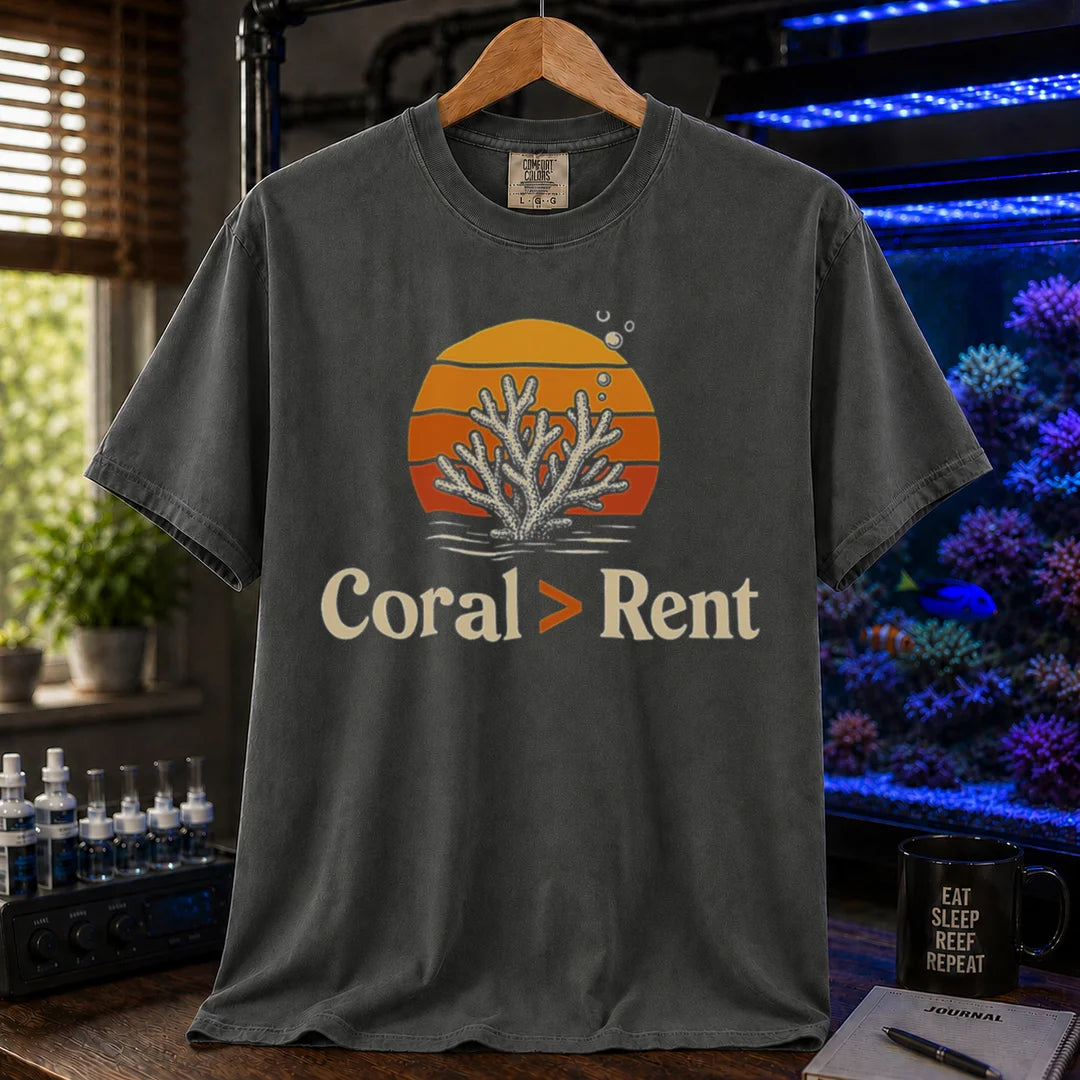 Saltwater aquarium graphic t-shirt featuring a retro sunset and coral illustration with text: Coral > Rent, khaki crew neck tee