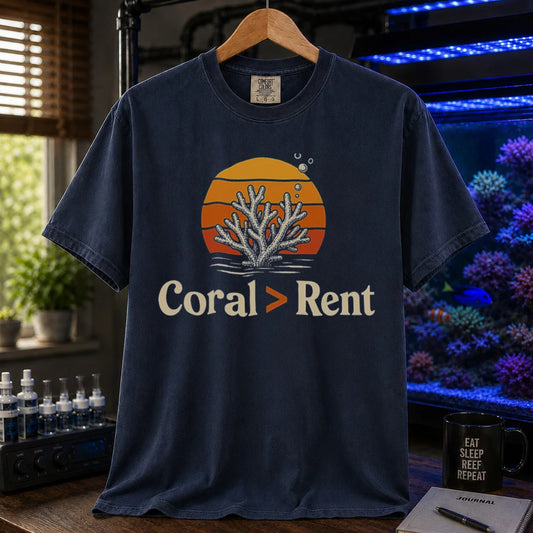 Saltwater aquarium graphic t-shirt featuring a retro sunset and coral illustration with text: Coral > Rent, navy crew neck tee