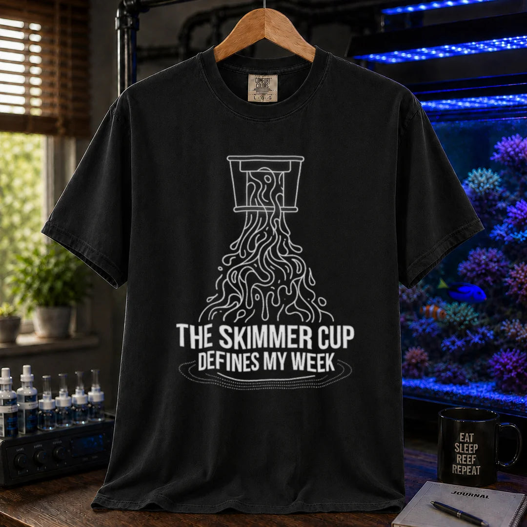 Saltwater aquarium graphic t-shirt featuring a line art illustration of a protein skimmer cup with text: THE SKIMMER CUP DEFINES MY WEEK, black crew neck tee