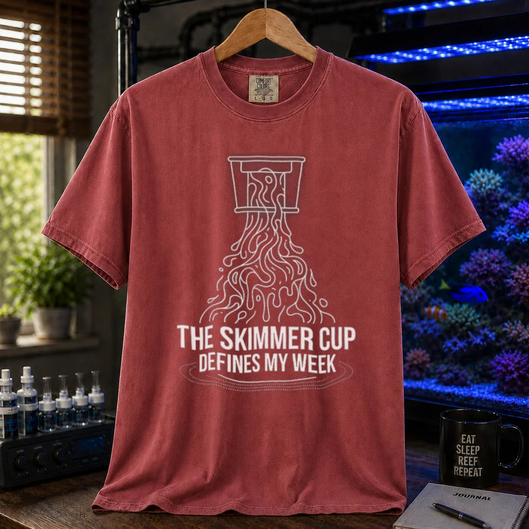 Saltwater aquarium graphic t-shirt featuring a line art illustration of a protein skimmer cup with text: THE SKIMMER CUP DEFINES MY WEEK, maroon crew neck tee