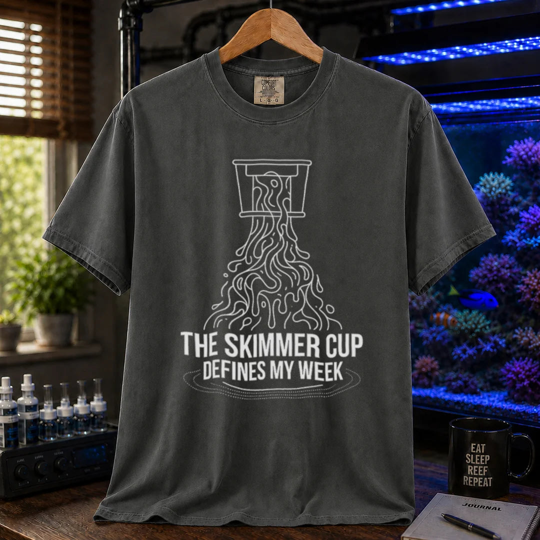 Saltwater aquarium graphic t-shirt featuring a line art illustration of a protein skimmer cup with text: THE SKIMMER CUP DEFINES MY WEEK, khaki crew neck tee