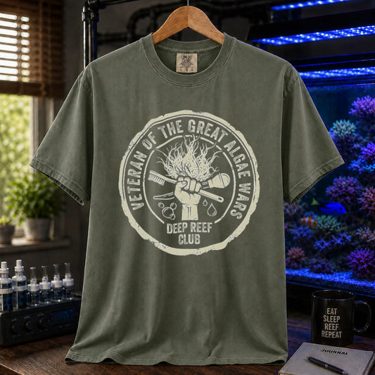 Saltwater aquarium graphic t-shirt featuring a circular emblem illustration with text: VETERAN OF THE GREAT ALGAE WARS DEEP REEF CLUB, military green crew neck tee