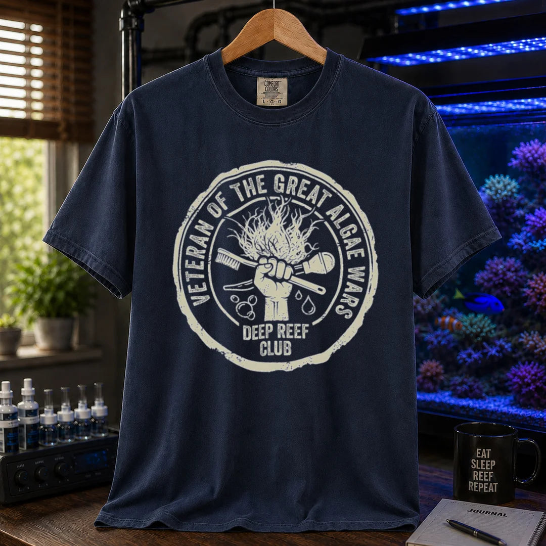 Saltwater aquarium graphic t-shirt featuring a circular emblem illustration with text: VETERAN OF THE GREAT ALGAE WARS DEEP REEF CLUB, navy crew neck tee