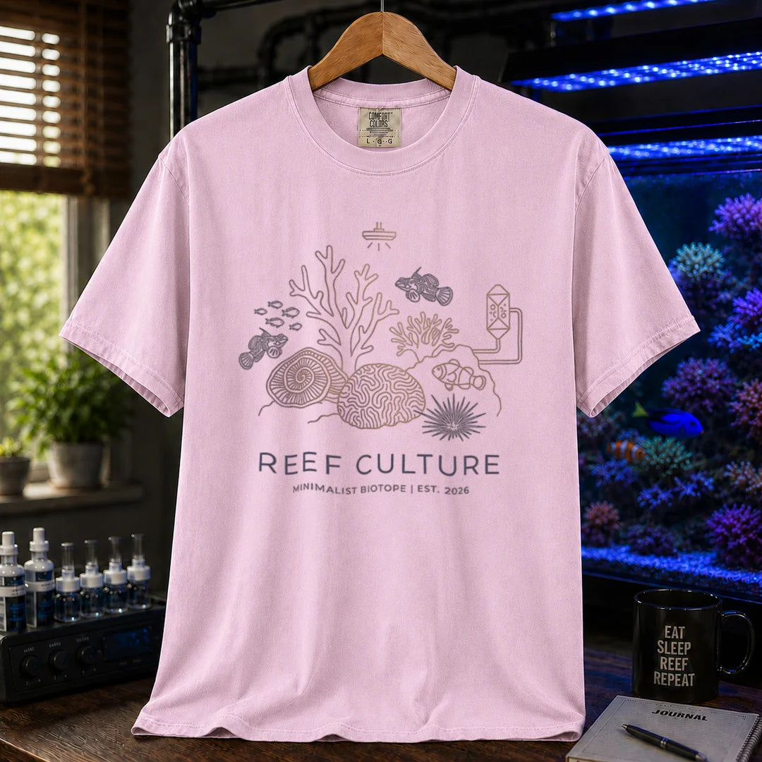 Saltwater aquarium graphic t-shirt featuring a minimalist line-art biotope illustration and text: REEF CULTURE MINIMALIST BIOTOPE | EST. 2026, pink crew neck tee