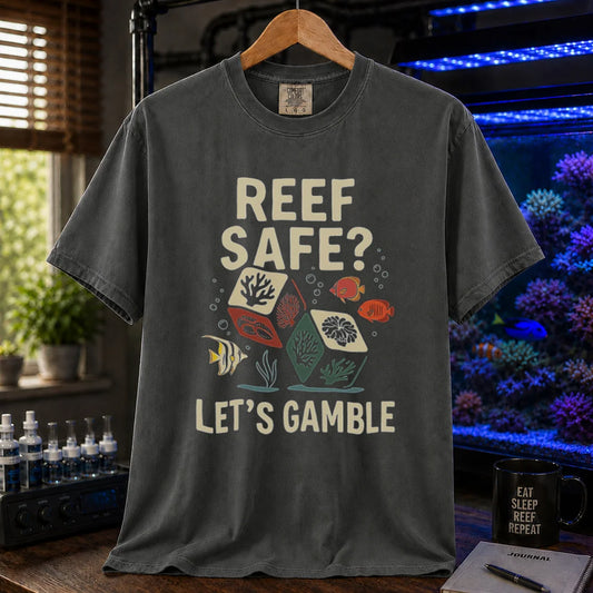 Saltwater aquarium graphic t-shirt featuring coral dice and fish illustrations with text: REEF SAFE? LET'S GAMBLE, khaki crew neck tee